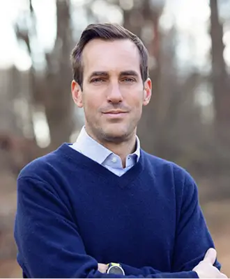 Attorney Randall Steketee, smiling, in a navy sweater outdoors